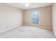 Neutral bedroom with a carpeted floor, ceiling fan, and a window with blinds at 310 Comeragh Se, Smyrna, GA 30080