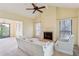 Bright living room with vaulted ceilings, fireplace, and a ceiling fan at 310 Comeragh Se, Smyrna, GA 30080