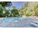 Community pool surrounded by trees and lounge chairs at 310 Comeragh Se, Smyrna, GA 30080