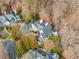 An aerial view displays a sprawling estate, its complex roofline set against a backdrop of mature trees at 675 W Paces Ferry Nw Rd, Atlanta, GA 30327