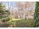 View of the private backyard with mature trees, landscaping, and a serene natural setting at 675 W Paces Ferry Nw Rd, Atlanta, GA 30327