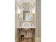 Stylish powder room with patterned wallpaper, ornate mirror, and marble countertop at 675 W Paces Ferry Nw Rd, Atlanta, GA 30327