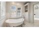 Bright bathroom showcasing a freestanding tub, white subway tile, and storage options at 675 W Paces Ferry Nw Rd, Atlanta, GA 30327