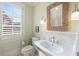 Cozy bathroom with patterned wallpaper, a woven mirror and natural light from the window at 675 W Paces Ferry Nw Rd, Atlanta, GA 30327