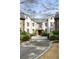 Elegant home exterior with stone and stucco, manicured landscaping, and a circular driveway at 675 W Paces Ferry Nw Rd, Atlanta, GA 30327