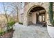 Stone exterior archway and walkway lead to the entrance of this luxury property at 675 W Paces Ferry Nw Rd, Atlanta, GA 30327