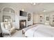 Elegant main bedroom boasting a marble fireplace, detailed trim, and built-in shelving at 675 W Paces Ferry Nw Rd, Atlanta, GA 30327