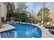 Gorgeous pool with a stone surround and a waterfall feature, creating a tranquil outdoor oasis at 675 W Paces Ferry Nw Rd, Atlanta, GA 30327