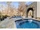 Inviting pool and spa area with lounge seating and a stone archway, perfect for relaxation and entertaining at 675 W Paces Ferry Nw Rd, Atlanta, GA 30327