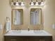 Modern bathroom featuring double sinks, a vanity with gold-trimmed mirrors, and stylish lighting at 6884 Robinson St, Lithonia, GA 30058