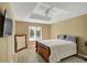 Primary bedroom showcasing a tray ceiling, a ceiling fan, and a decorative vintage style mirror at 6884 Robinson St, Lithonia, GA 30058