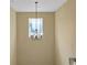 A charming chandelier over the stairs with a light-colored wall at 6884 Robinson St, Lithonia, GA 30058