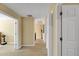 Hallway with a view of the door and a light-colored wall and wooden floors at 6884 Robinson St, Lithonia, GA 30058