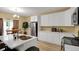 Modern kitchen featuring white cabinetry and stainless steel appliances and an eat-in kitchen area at 6884 Robinson St, Lithonia, GA 30058