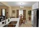 Open concept kitchen with stainless steel sink and view of living room, enhancing the connectivity of the home at 6884 Robinson St, Lithonia, GA 30058