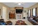 Bright living room featuring sleek flooring, a stone fireplace, and ample natural light at 6884 Robinson St, Lithonia, GA 30058