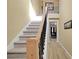 Interior staircase with carpeted steps, wooden handrail, and black iron spindles at 6884 Robinson St, Lithonia, GA 30058