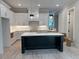 Spacious kitchen featuring a black island with white marble countertop and modern lighting fixtures at 004 White St # 4, Marietta, GA 30060