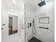 Stylish bathroom with elegant marble tile, a rainfall showerhead, and modern fixtures in black and white at 1300 Indian Nw Trl, Atlanta, GA 30327