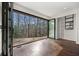 Open living area with wood floors and expansive folding glass doors to the outside at 1300 Indian Nw Trl, Atlanta, GA 30327