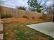 Fenced backyard featuring landscaping with a concrete patio perfect for outdoor activities at 180 S Alexander St, Buford, GA 30518