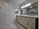 Bathroom featuring double vanity, marble countertops, and stylish cabinetry at 180 S Alexander St, Buford, GA 30518