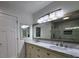 Bathroom featuring a double vanity with marble countertop and decorative lighting at 180 S Alexander St, Buford, GA 30518