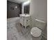 Bathroom featuring a tiled floor, tub, toilet, and vanity at 180 S Alexander St, Buford, GA 30518