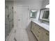 Modern bathroom with marble countertop vanity, glass shower, and tiled floor at 180 S Alexander St, Buford, GA 30518