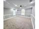 Spacious bedroom with plush carpet, tray ceiling, and ample natural light at 180 S Alexander St, Buford, GA 30518