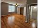 Spacious bedroom with hardwood floors, ceiling fan, and large windows at 180 S Alexander St, Buford, GA 30518