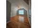 Bedroom featuring hardwood floors, gray walls, a ceiling fan, and a large window at 180 S Alexander St, Buford, GA 30518