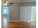 Bedroom featuring hardwood floors, gray walls, a ceiling fan, and a window at 180 S Alexander St, Buford, GA 30518