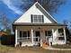 Beautiful white home with black shutters and a cozy front porch at 180 S Alexander St, Buford, GA 30518
