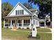 Charming white farmhouse-style home with a welcoming front porch and manicured lawn at 180 S Alexander St, Buford, GA 30518