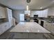 Stylish kitchen with stainless steel appliances, white cabinets, and a large island with counter seating at 180 S Alexander St, Buford, GA 30518