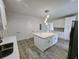 Contemporary kitchen featuring a central island, stainless appliances, and sleek white cabinetry at 180 S Alexander St, Buford, GA 30518