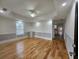 Spacious living room featuring hardwood floors, tray ceiling, and modern recessed lighting at 180 S Alexander St, Buford, GA 30518