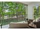 Inviting balcony with wicker furniture overlooking a serene wooded landscape at 2769 Peachtree Ne Rd # 4, Atlanta, GA 30305