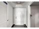 Clean entryway with a white door, geometric patterned rug, and neutral color scheme at 2870 Pharr Court S Nw # 2006, Atlanta, GA 30305