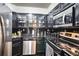 Modern kitchen with stainless steel appliances, black countertops, and dark cabinetry at 2870 Pharr Court S Nw # 2006, Atlanta, GA 30305
