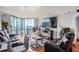Bright living room with city views, large windows, modern furniture, and a sleek entertainment center at 2870 Pharr Court S Nw # 2006, Atlanta, GA 30305