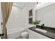 Modern bathroom features a shower over tub, a sleek vanity, and neutral finishes at 313 Canoe Pl, Villa Rica, GA 30180