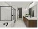 Contemporary bathroom with a walk-in shower, soaking tub, dual vanity, and tile flooring at 313 Canoe Pl, Villa Rica, GA 30180