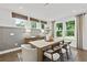 Bright dining area features a large table, wood accents, and views of the outdoors at 313 Canoe Pl, Villa Rica, GA 30180