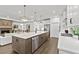 Bright, open kitchen featuring a large island, modern appliances, and seamless flow to the living area at 313 Canoe Pl, Villa Rica, GA 30180