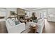Open-concept living room with fireplace, hardwood floors, and comfortable seating at 313 Canoe Pl, Villa Rica, GA 30180