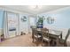 Light-filled dining room with large windows, a modern light fixture, and stylish decor, perfect for entertaining at 615 Heartwood Se Way, Conyers, GA 30094