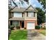 Charming two-story home featuring well-manicured lawn, brick facade, and attached garage at 164 Haven Oak Way, Lawrenceville, GA 30044