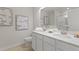 Modern bathroom featuring double sinks, quartz countertop, and a glass enclosed shower at 308 Navigator Ln, Mcdonough, GA 30253